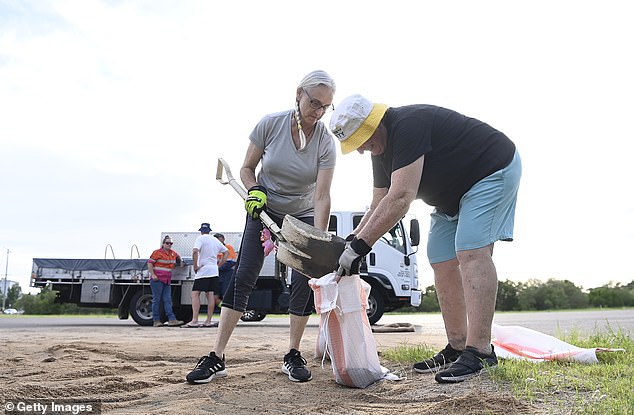 Five fire and rescue teams are stationed in Townsville (pictured, locals fill sandbags)