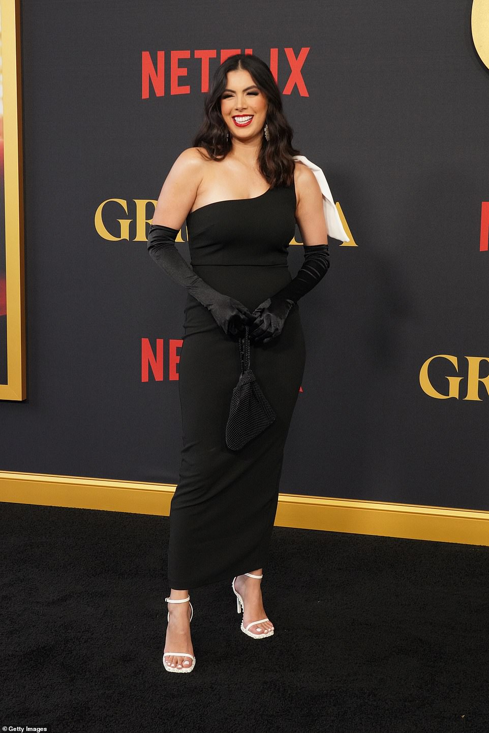 Adriana Paniagua, 28, was also spotted at the premiere in a chic one-shoulder dress, matching velvet opera gloves and a beaded bag