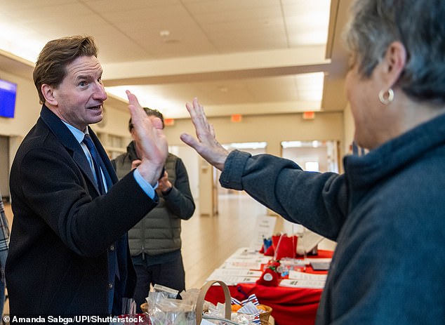 Phillips high-fives a potential supporter while campaigning in New Hampshire on Tuesday's primary.  The Minnesota congressman said he planned to continue his campaign and participate in the primaries in South Carolina and Michigan