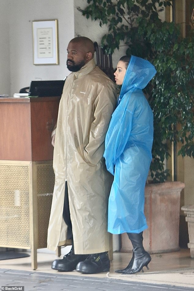 Kanye and his wife appeared to be waiting with the clerk