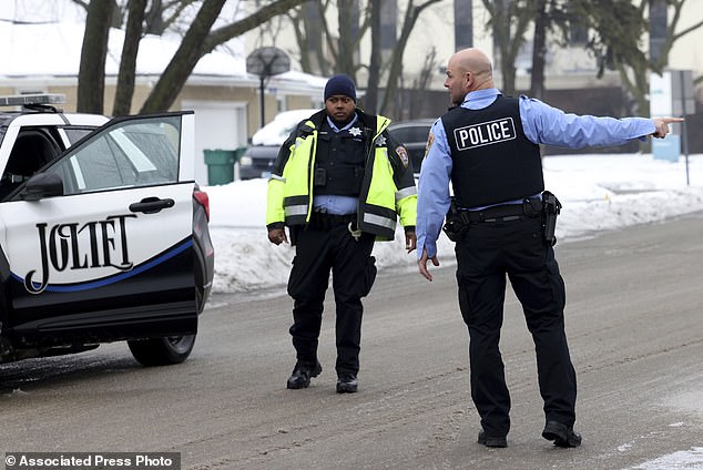 Joliet police officers work at the scene Tuesday where several people were shot