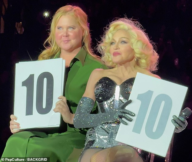 Fans cheered as both held up signs with the number 10, indicating their satisfaction with Madonna's stage company