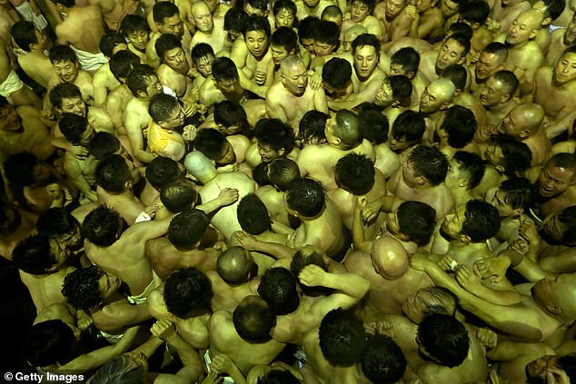 Participants compete to find a sacred stick thrown by temple priests during the Naked Festival, or Hadaka Matsuri at Saidaiji Temple on February 16, 2019