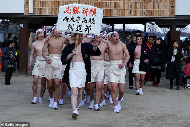 Participants arrive to take part in the Naked Festival, or Hadaka Matsuri at Saidaiji Temple on February 16, 2019