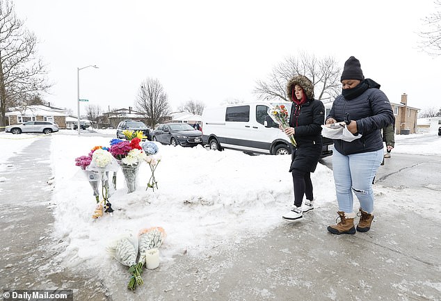 Friends of Halema, Zahia, Hannan and Majeda Kassem, who were murdered on Sunday, bring flowers and candles to the side of Kassem's house, on Monday, January 22, 2024