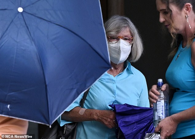 The couple were protected with umbrellas by their family and friends in an attempt to avoid being photographed