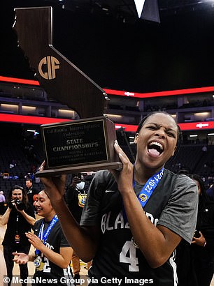 MacKenly Randolph #4 of Sierra Canyon then celebrates with the trophy after defeating Archbishop Mitty 85-61 to win the CIF Open Division girls basketball state championship