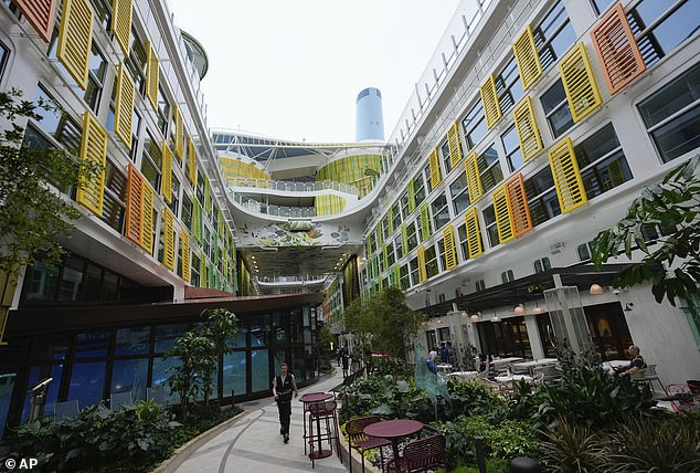 An employee walks through the Central Park part of the ship, because it also has its own 'family neighborhood' called 'Surfside'