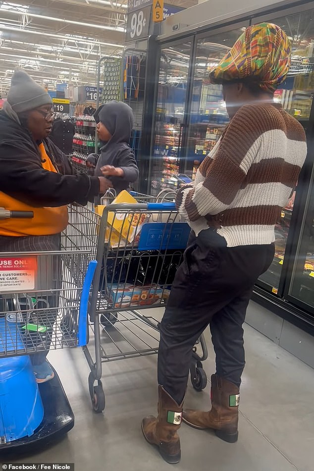 While she dressed the toddler, his mother stood next to the cart playing on her phone