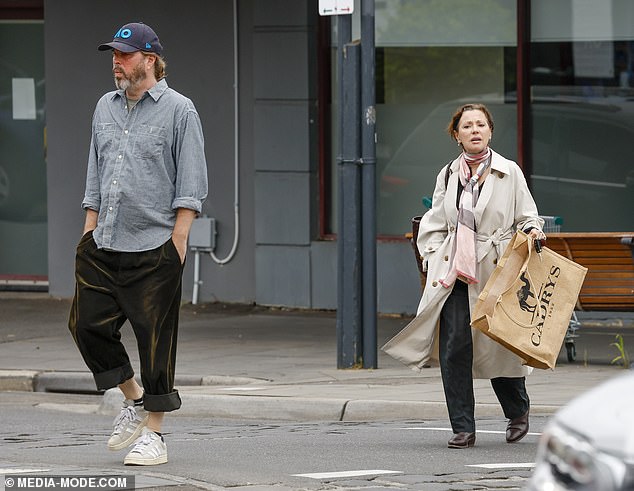 Tina's partner of almost three years rocked a pair of felt brown pants and a faded button down, rolled up his sleeves and turned up his pants.