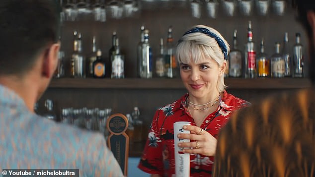 A bartender smiles back at Lionel Messi during a Super Bowl LVIII ad for Michelob