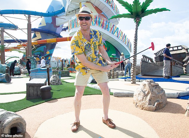 Thomas practices his short game on a miniature golf course on the sunny deck aboard the enormous ship