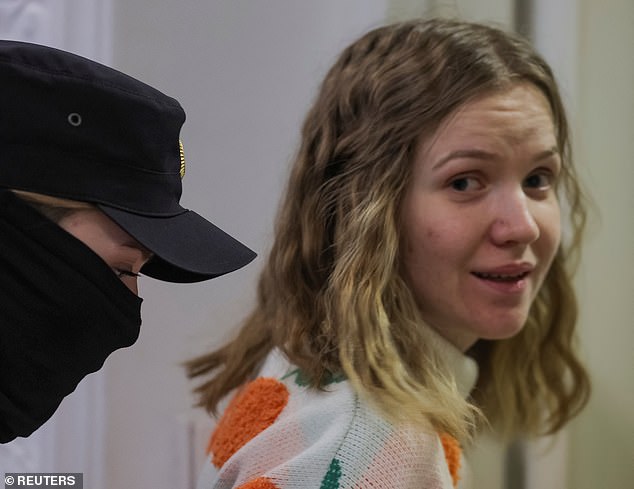 In court for the sentencing, Trepova sat in a glass box in front of the defendants, wearing a white turtleneck sweater with a pattern of large knitted oranges.  She was seen smiling in court after her sentencing, before being led away to begin her prison sentence (pictured)