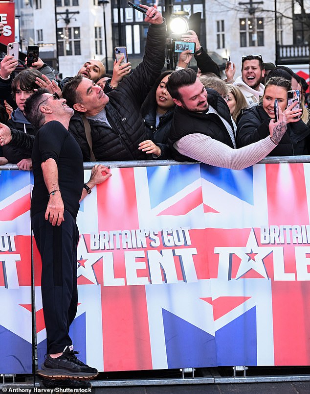 A cheerful Cowell was also happy to indulge waiting fans with repeated requests for selfies and autographs after arriving in a casual lycra top and black sweatpants.