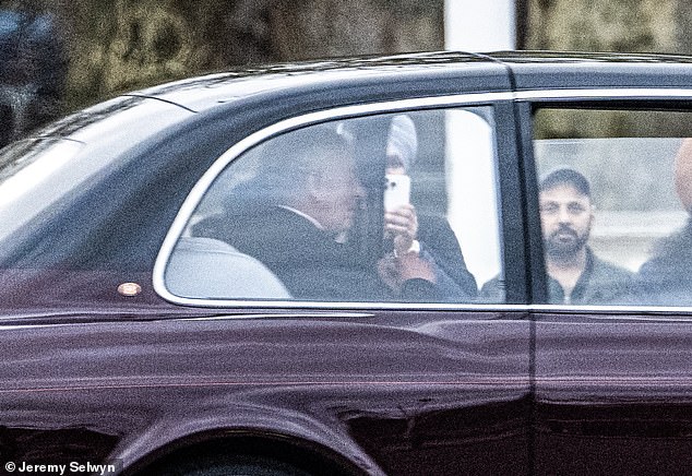 The 75-year-old monarch sat in the back of a liveried car as it drove past some spectators down the Mall