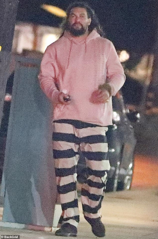 Even in a sober mood, he managed to cut a fashionable figure in a statement striped sweater and a cozy-looking pink hoodie.