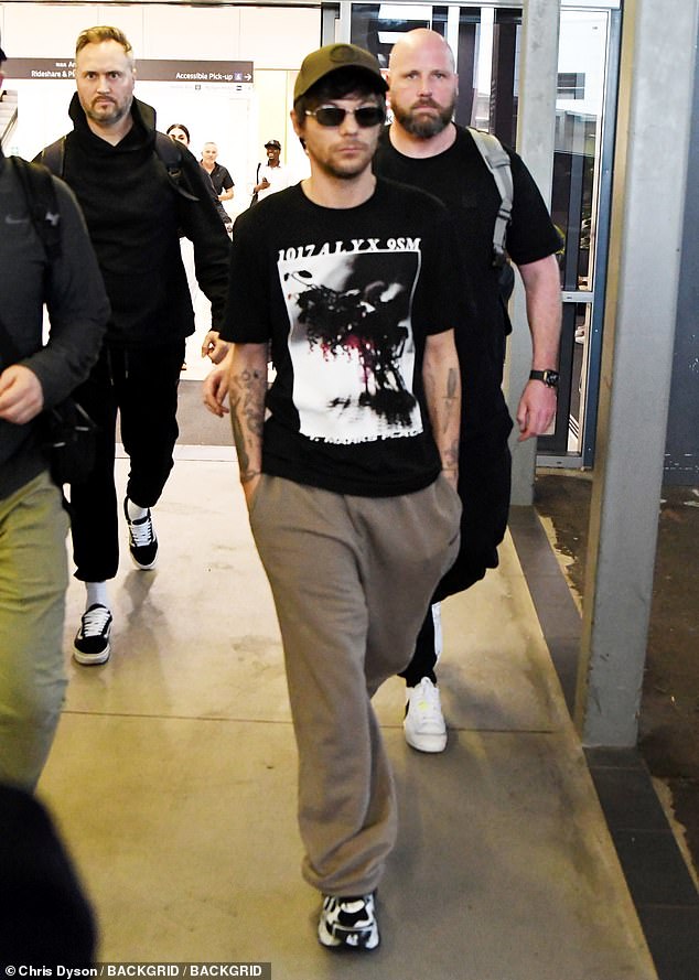 The former One Direction star, 32, looked every bit the casual rock star as he was spotted making his way through the terminal in a graphic T-shirt and sweatpants