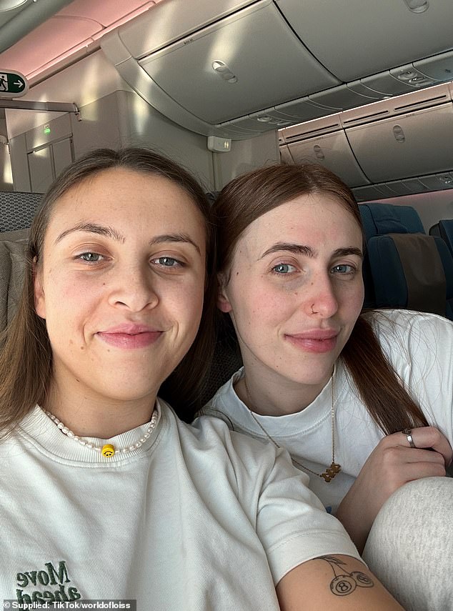 Two days after arriving, her left calf became swollen, 'warm' and felt as if she had 'pulled a muscle' (Lois pictured left with her partner on the flight)