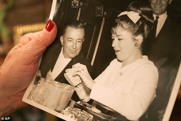 Charolette Richards holds a photo of her with her ex-husband, Merle Richards