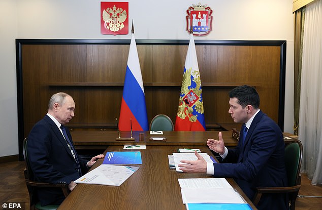 Putin listens to the governor of the Kaliningrad region, Anton Alikhanov, during a meeting on Thursday