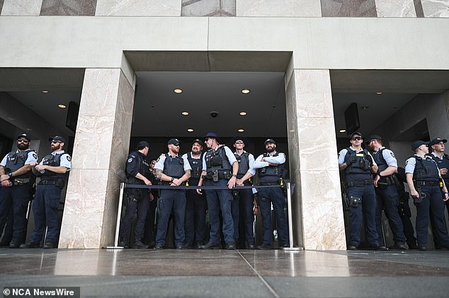 Police set up a barricade at the entrance to Parliament House on Friday