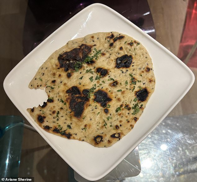 The Chicken Tikka Masala is served with a naan bread, pictured