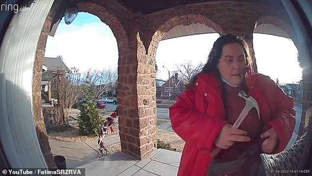 Judy Kline is seen with a hammer outside the Suarez family home in St. Louis, Missouri.  Kline was eventually arrested for threatening the family