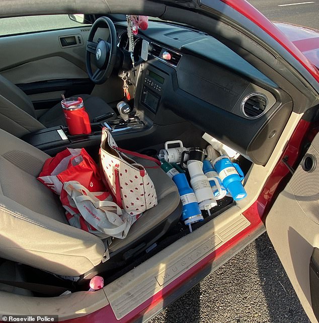 More cups were found on the floor of the front passenger seat, while an unusual bright red Stanley cup was in the cup holder of her car