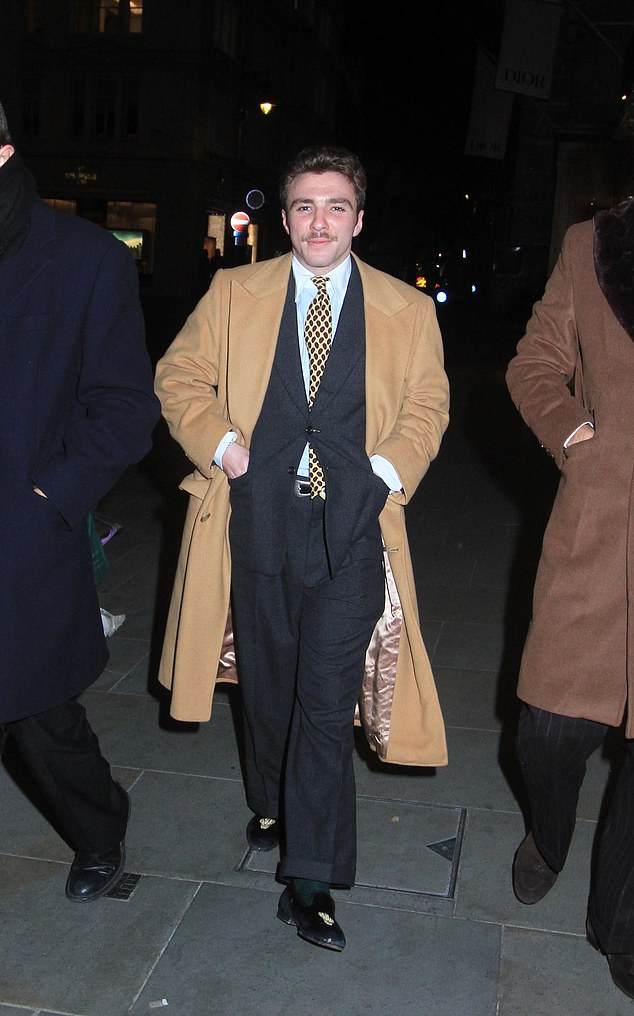 The painter paired his camel coat with a smart suit and white shirt and kept his hands in his pockets as he was pictured out and about in London.