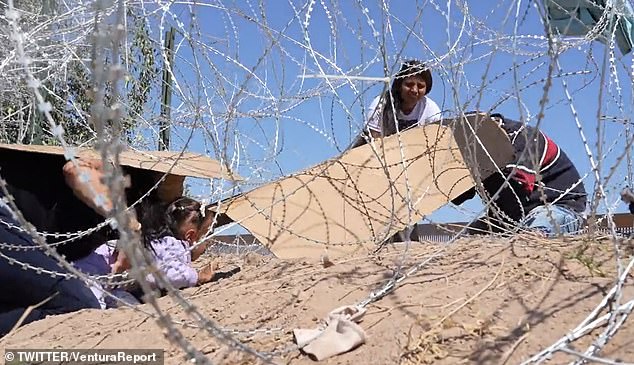 A group of Venezuelans used cardboard on their backs to avoid being cut as they crawled under a barbed wire barrier erected to prevent migrants from entering El Paso, Texas.