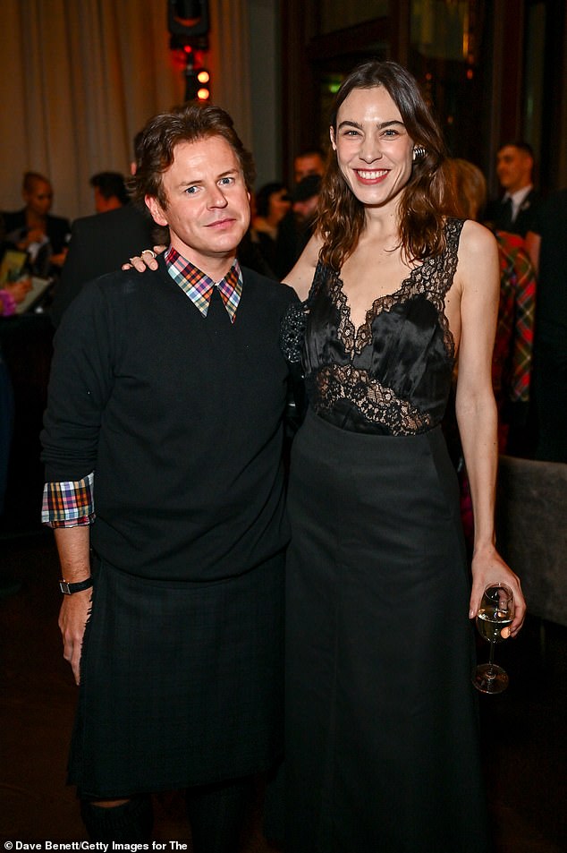 Alexa also wore a black skirt and added height to her body with a pair of baby blue heels (pictured with fashion designer Christopher Kane)