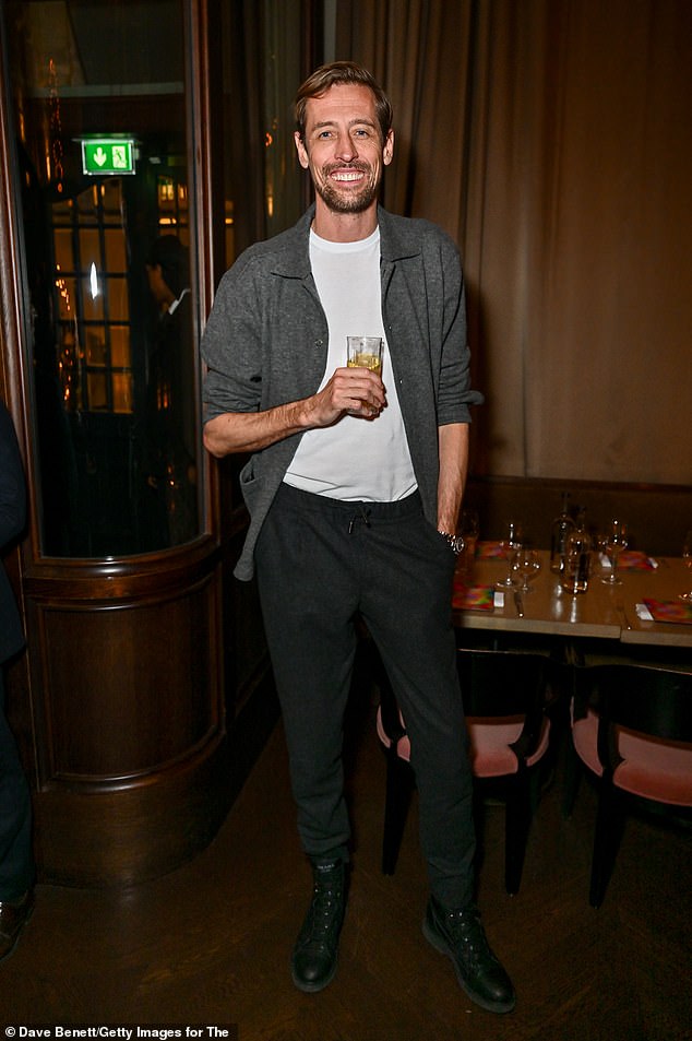 Peter Crouch opted for a relaxed look in a white T-shirt with gray trousers and a matching jacket