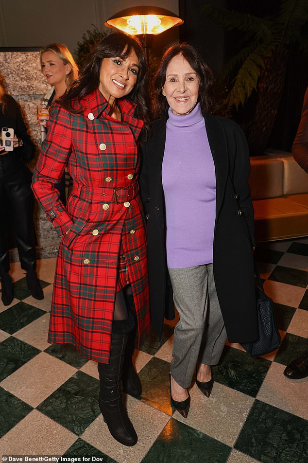 Arlene Phillips kept it casual in a purple turtleneck sweater and gray pants as she posed next to former Page Three girl Jackie Michaelson