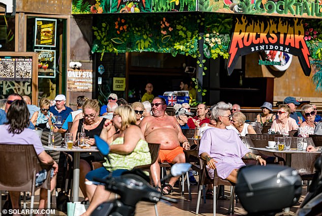 Today we see holidaymakers enjoying the sun in a bar in Benidorm, Spain