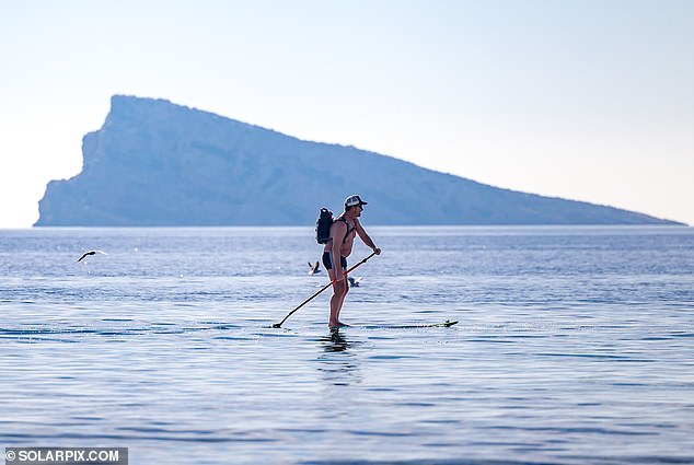 A man is seen paddle boarding in Benidorm as people enjoy the scorching January temperatures