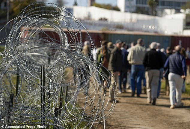 Concertina wire forms the path as members of Congress tour an area near the Texas-Mexico border, January 3, 2024