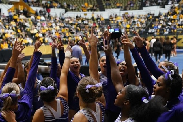 The LSU gymnastics team warms up for a match at Missouri, which it ultimately lost