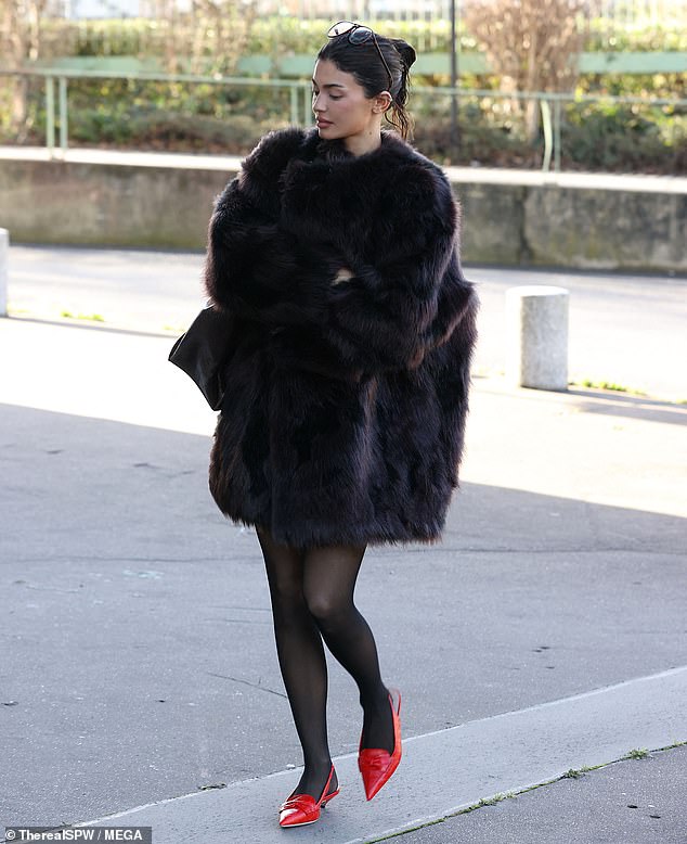 The TV personality put on a leggy show, wearing a dark brown faux fur coat with a hem that stopped a few inches above her knees