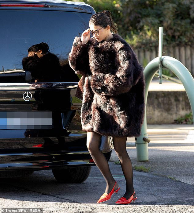 She opted to don sheer, black tights and red closed-toe pumps that added a pop of color to the look.