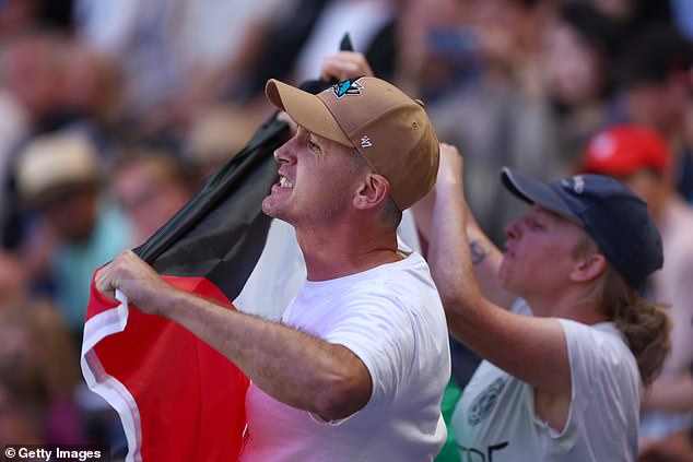 The man and several others stood up in the second set and shouted their message across the stadium