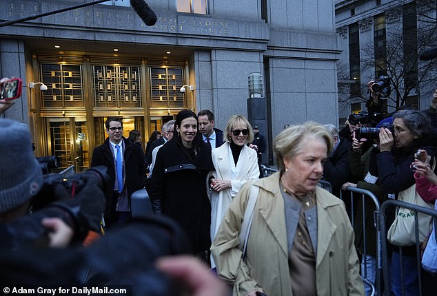 Carroll and her attorneys walked out of the courtroom arm in arm with big smiles on their faces