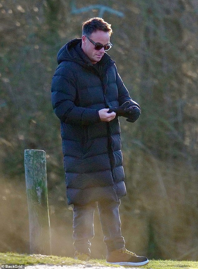 Ant covered himself against the cold weather in a black puffed coat and matching gloves