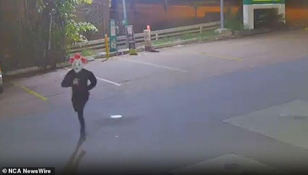 The masked robber was captured on CCTV running towards the servo at around 7.30pm