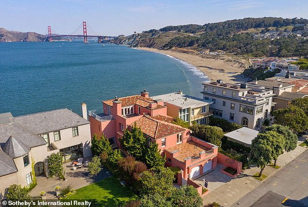 Built in 1925, the property features seven bedrooms, six bathrooms, formal living and dining rooms, a wine cellar, a top-floor family room, two fireplaces, and a path leading to a secluded cove where dolphins are often spotted in the waves. seen.