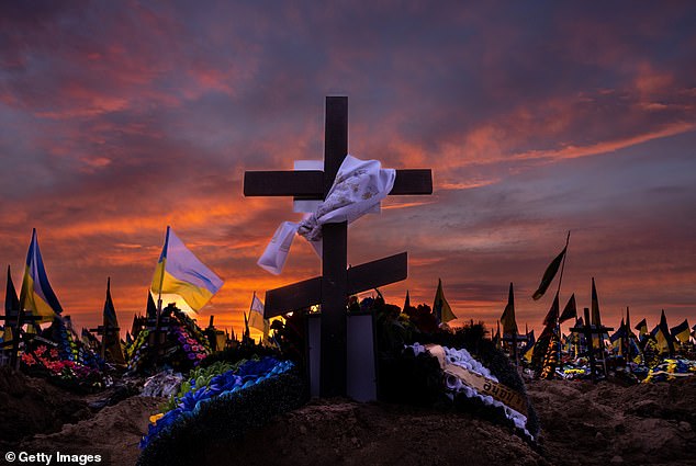 The war that bankrupt Britain has struggled to sustain has killed, maimed and disfigured unknown tens of thousands of young Ukrainian men, destroyed cities and devastated the Ukrainian economy.  (Pictured: Military graves at a cemetery in Kharkiv)