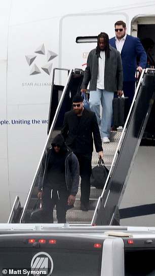 Travis Kelce is seen with several Chiefs teammates, including center Creed Humphrey at the top of the steps