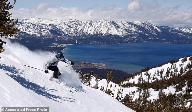 A skier throws up some powder at Heavenly Ski Resort, in South Lake Tahoe, California