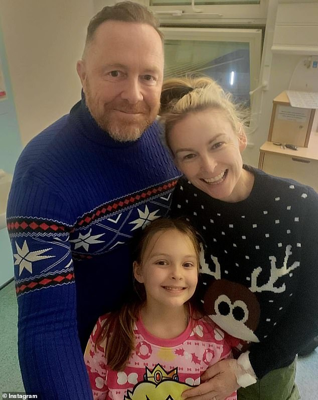 It comes after the relationship expert recently underwent surgery to remove bowel cancer and announced on Instagram that she was heading home from hospital in London to spend Christmas Day with her family.  (Pictured with husband Gareth Brisbane, 51, and their daughter Madison, eight)