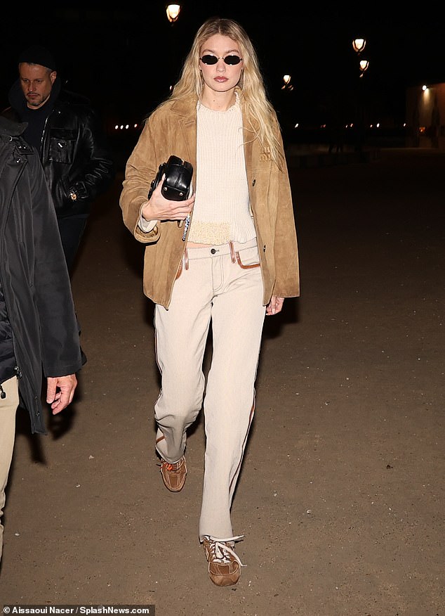 The supermodel stunned in a maple brown Miu Miu jacket worth €4,700 to complement her stylish cream ensemble