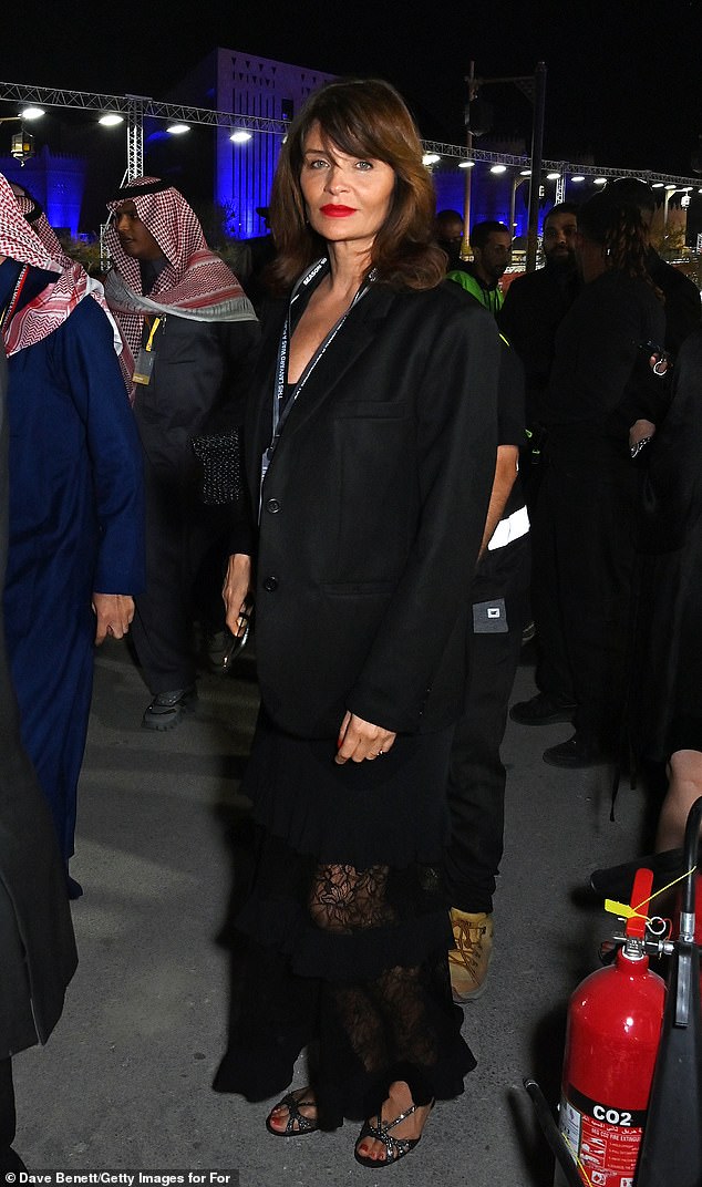 The supermodel dazzled in a sheer black dress for the occasion and complemented her look with a chic blazer jacket